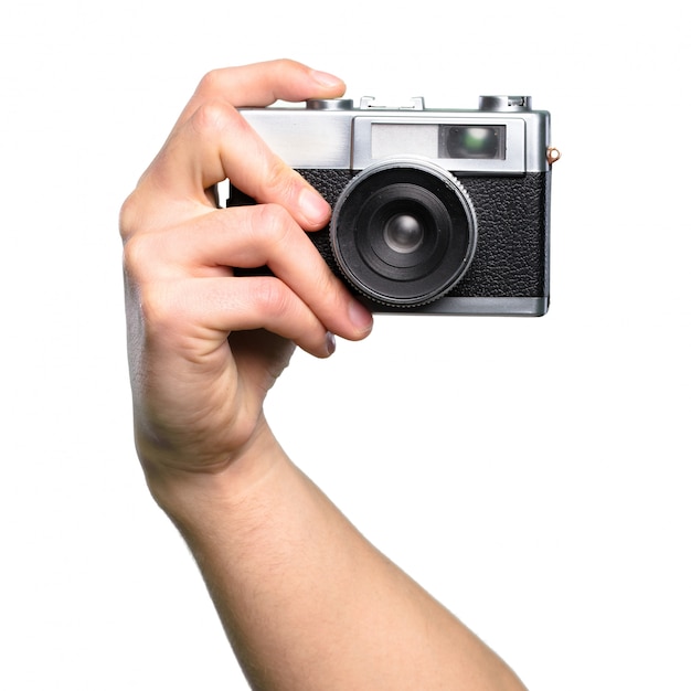 Hand holding Camera over isolated white background