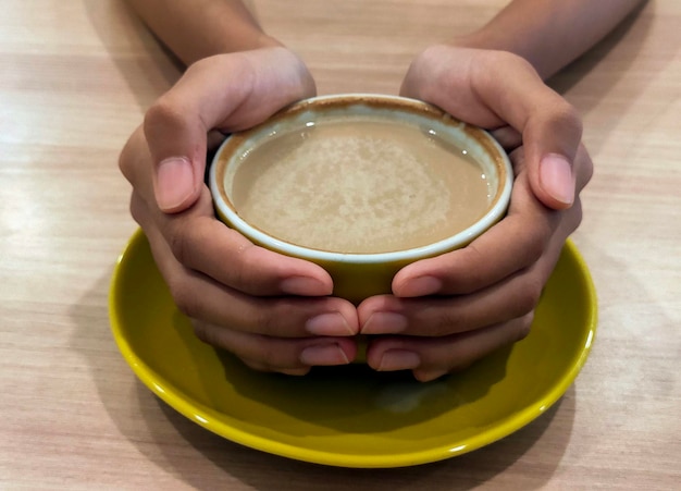 Hand holding cappucino