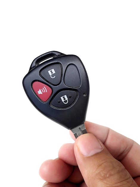 Hand holding the car key Isolated on white background