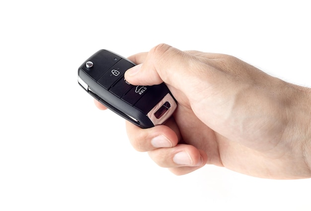 A hand holding a car key that says s on it