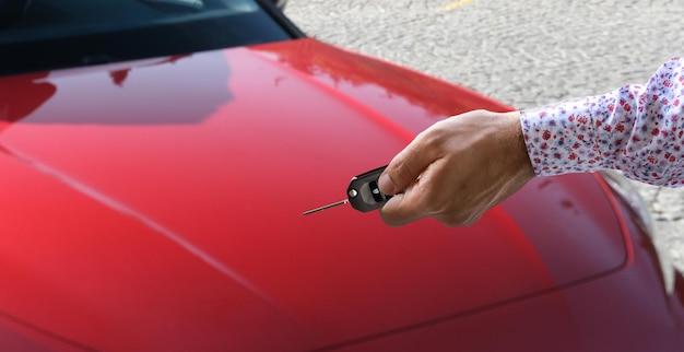 Hand holding car key