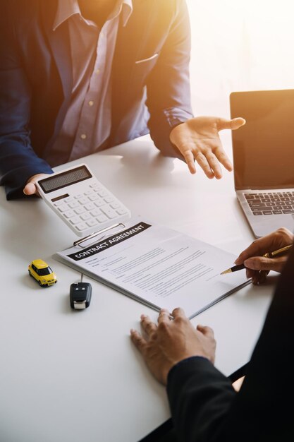 Hand holding car keys and car rental concept A closeup view of the agent giving the customer the car keys after signing the lease rental form and car name