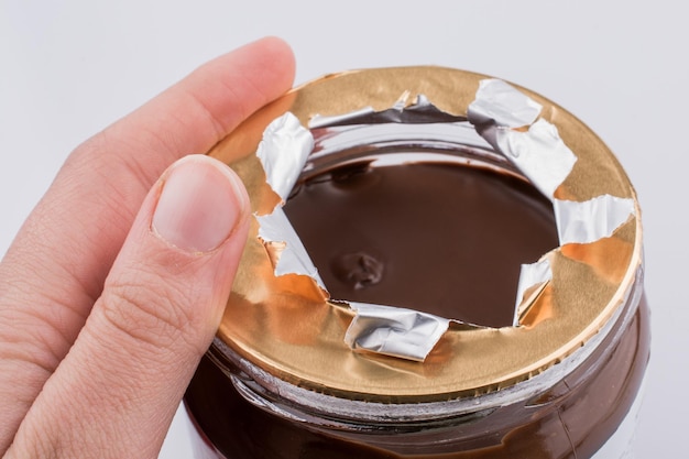 Hand holding a chocolate jar ias healthy snack