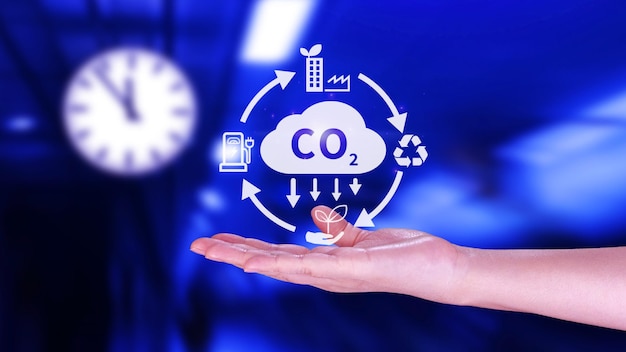 Hand holding CO2 reducing virtual icon for decrease carbon dioxide emission carbon footprint and carbon credit to limit global warming from Bio climate change concept