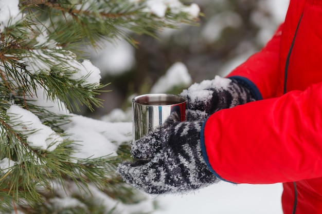 Hand holding coffee cup, outdoors