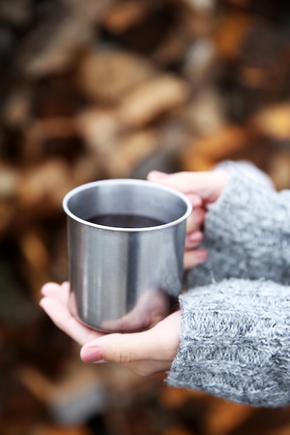 Hand holding coffee cup outdoors