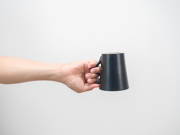 Hand holding coffee cup upside down isolated