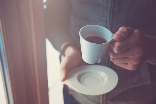 Hand holding coffee cup