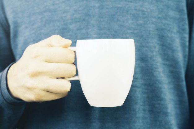 Hand holding coffee cup