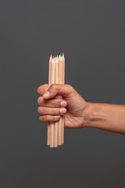 Hand holding colored crayons