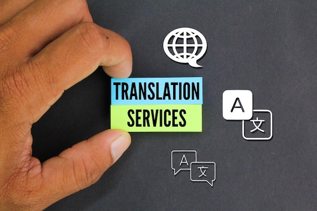 hand holding colored paper with icon and word Translation Services