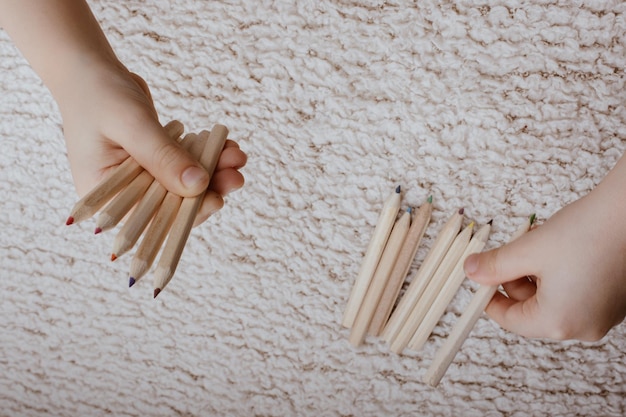 Hand holding colored pencils for creative idea and concept