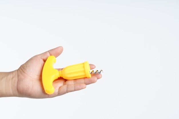 Hand holding corkscrew with plastic handle