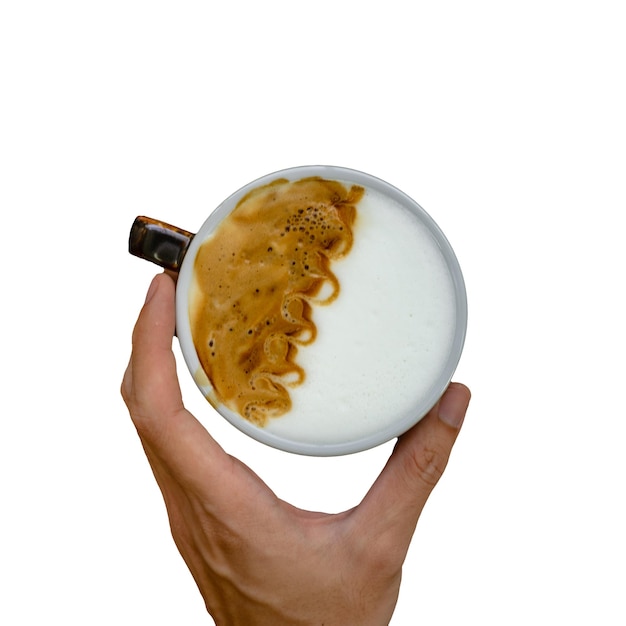 A hand holding a cup of coffee with a foamy liquid on it.