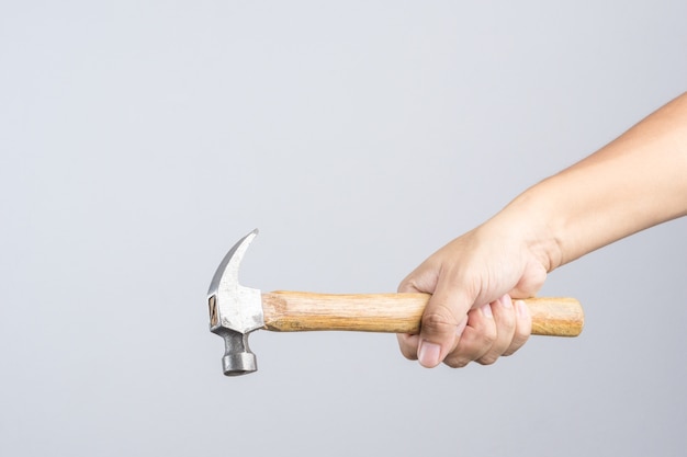 Hand holding custom wooden grip hammer