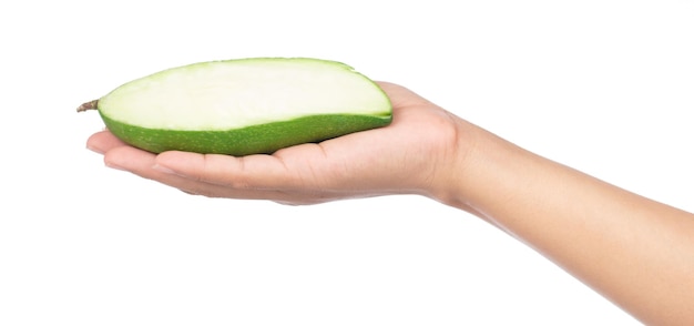 hand holding cut of green mango isolated on a white background.