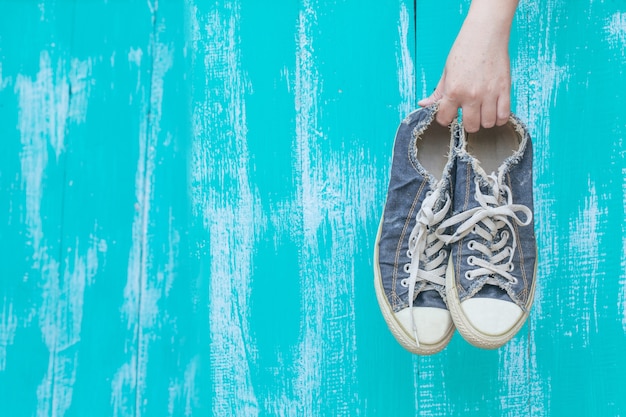 Hand holding a dirty shoe