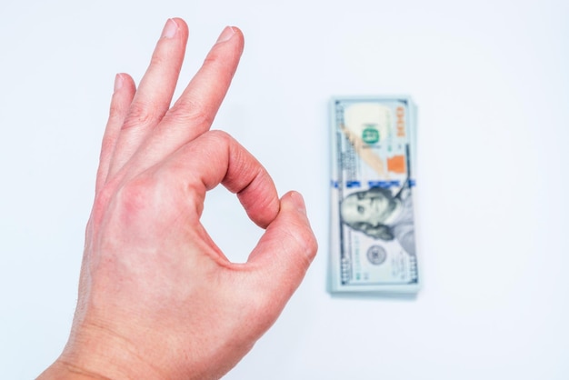 Hand holding dollars on white backgrounds. Isolated