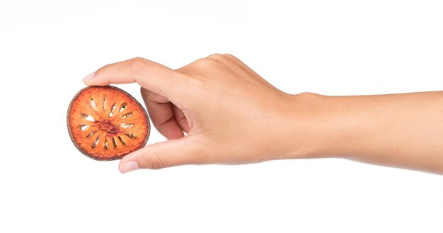hand holding Dried bale fruit, quince slices isolated on a white background