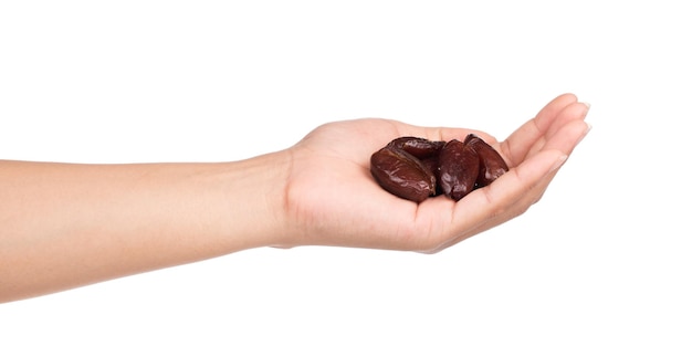 hand holding Dried halawi dates isolated on a white background.