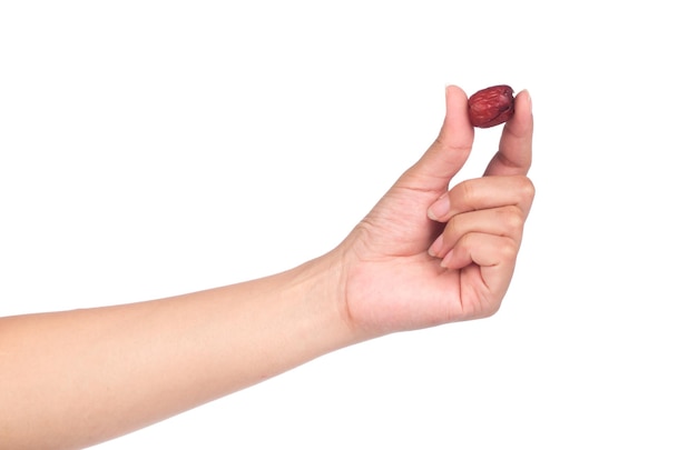 hand holding Dried red date or Chinese jujube isolated on white background