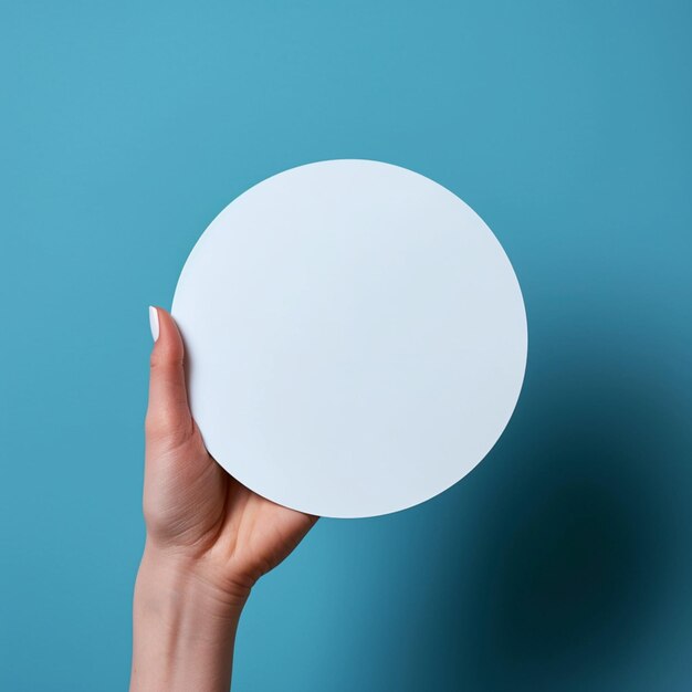 Hand holding empty white circle mockup on blue backdrop For Social Media Post Size