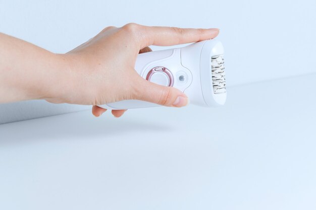 Hand holding epilator