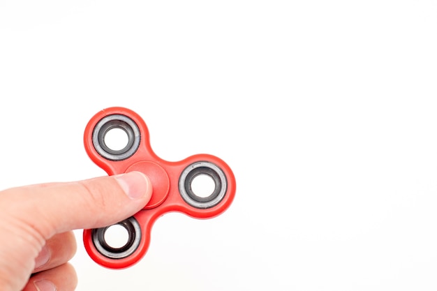 Hand holding fidget spinner toy isolated