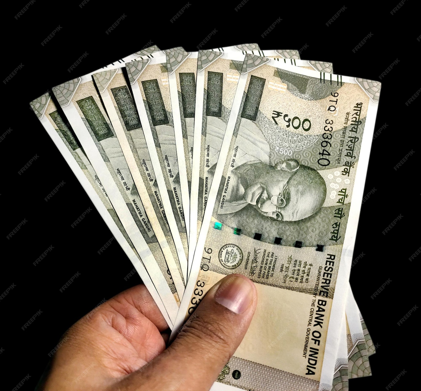premium-photo-hand-holding-five-hundred-indian-rupee-notes-against