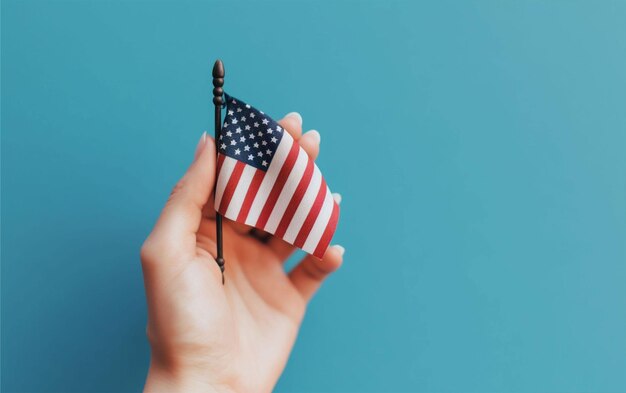 Hand holding flag of America while celebrating national holiday