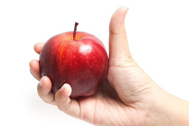 hand holding fresh organic red apple fruit with thumb finger isolated on white background