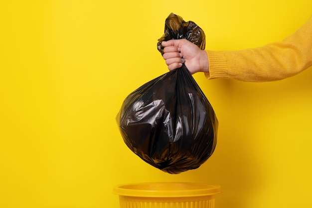 Hand holding garbage bag