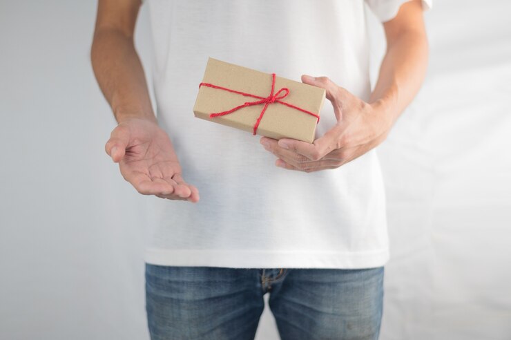 Hand holding gift box, new year gift box, Christmas gift box ,copy space. Christmas, hew year, birthday concept.