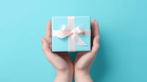 Photo hand holding gift box on pastel blue background