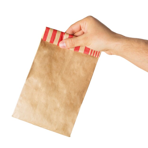 Hand holding or giving a brown paper bag