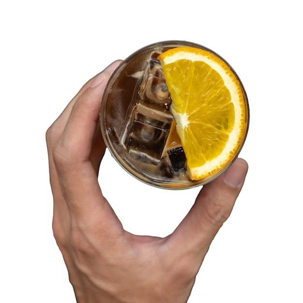 A hand holding a glass of alcohol with a slice of orange on it.