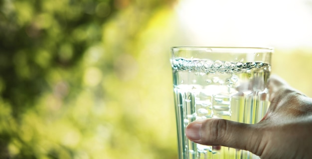 Hand Holding a Glass of Drinking Water