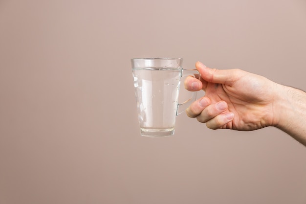 hand holding glass of water