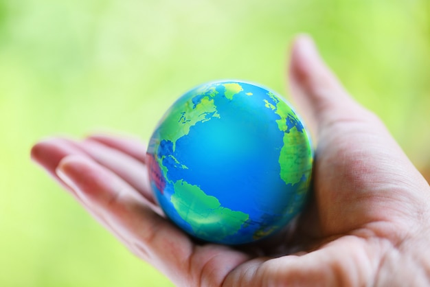 hand holding globe with map and environment green planet save the earth