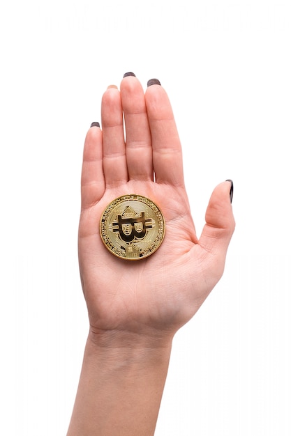 Hand holding golden Bitcoin