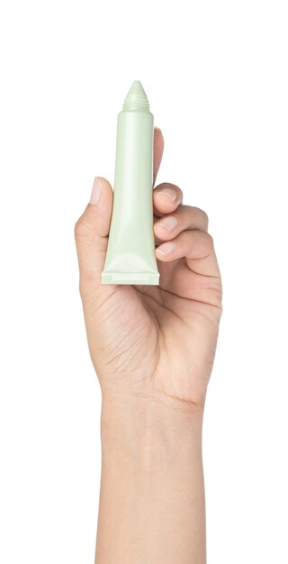 hand holding Green cosmetic tube isolated on a white background.