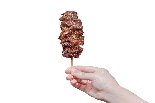 Hand holding grilled pork in bamboo stick isolate on white backgroundImage of grilled pork in hand thai food style