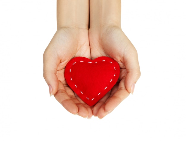 Hand holding the heart isolated on white 