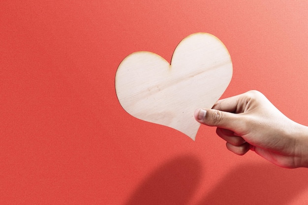 Hand holding hearts with a colored background. Valentines day