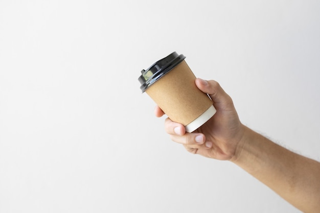 Hand holding a hot coffee cup