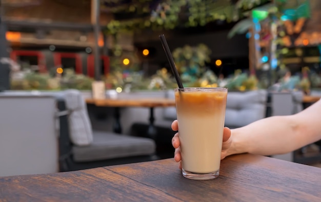 Hand holding ice coffee