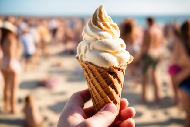 Photo hand holding ice cream cone at beach