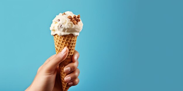 Hand holding ice cream cup isolated in blue background color