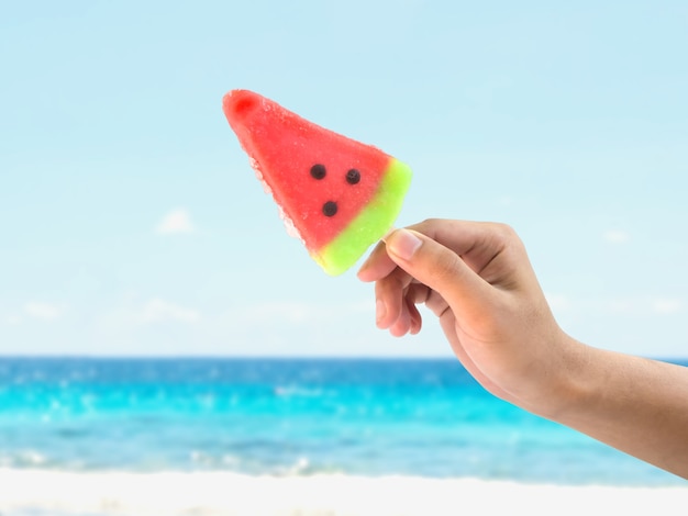 Hand holding ice cream watermelon shape 