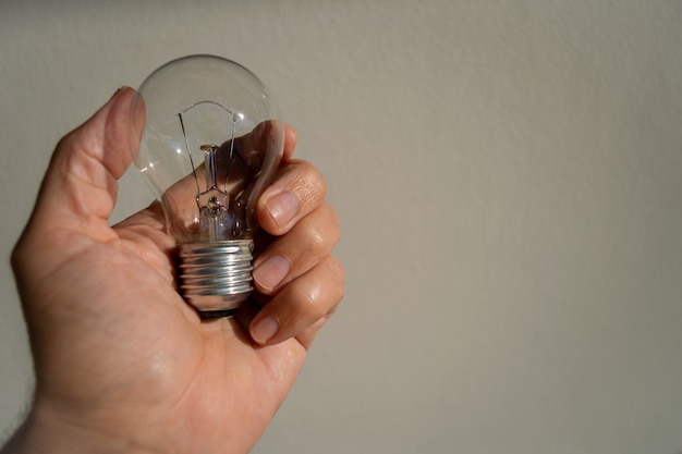 Hand holding incandescent lamp